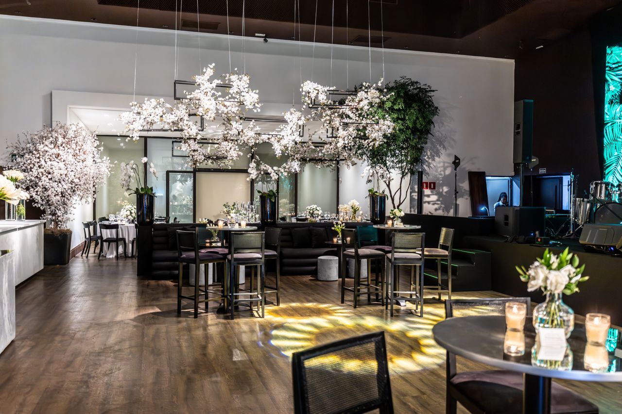 Luxurious banquet hall interior with floral decorations and elegant furniture setup, perfect for weddings or events.