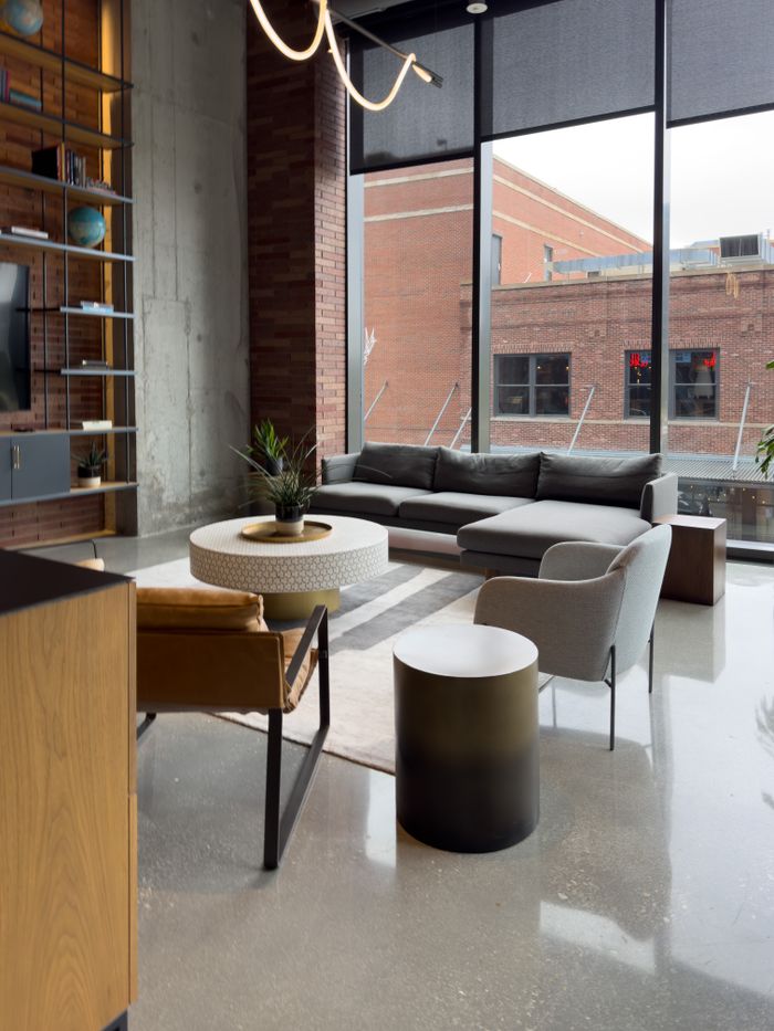 Sleek contemporary lounge area featuring stylish furniture and floor-to-ceiling windows.